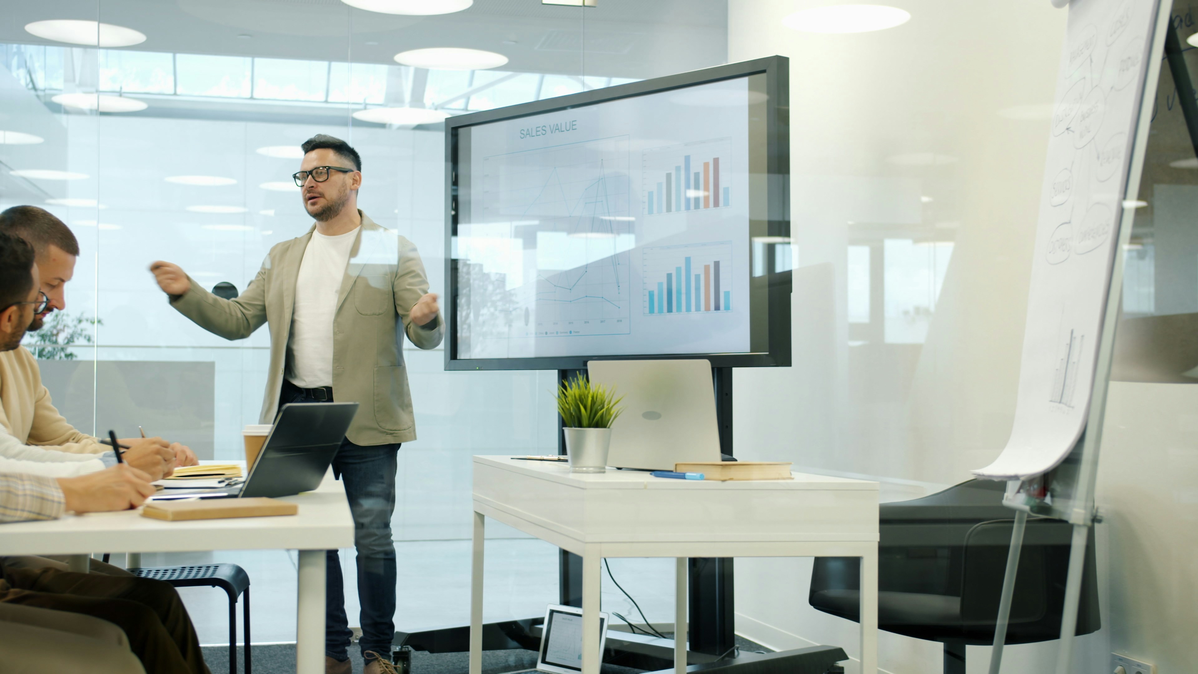 Business owner reviewing sales charts during a financing discussion